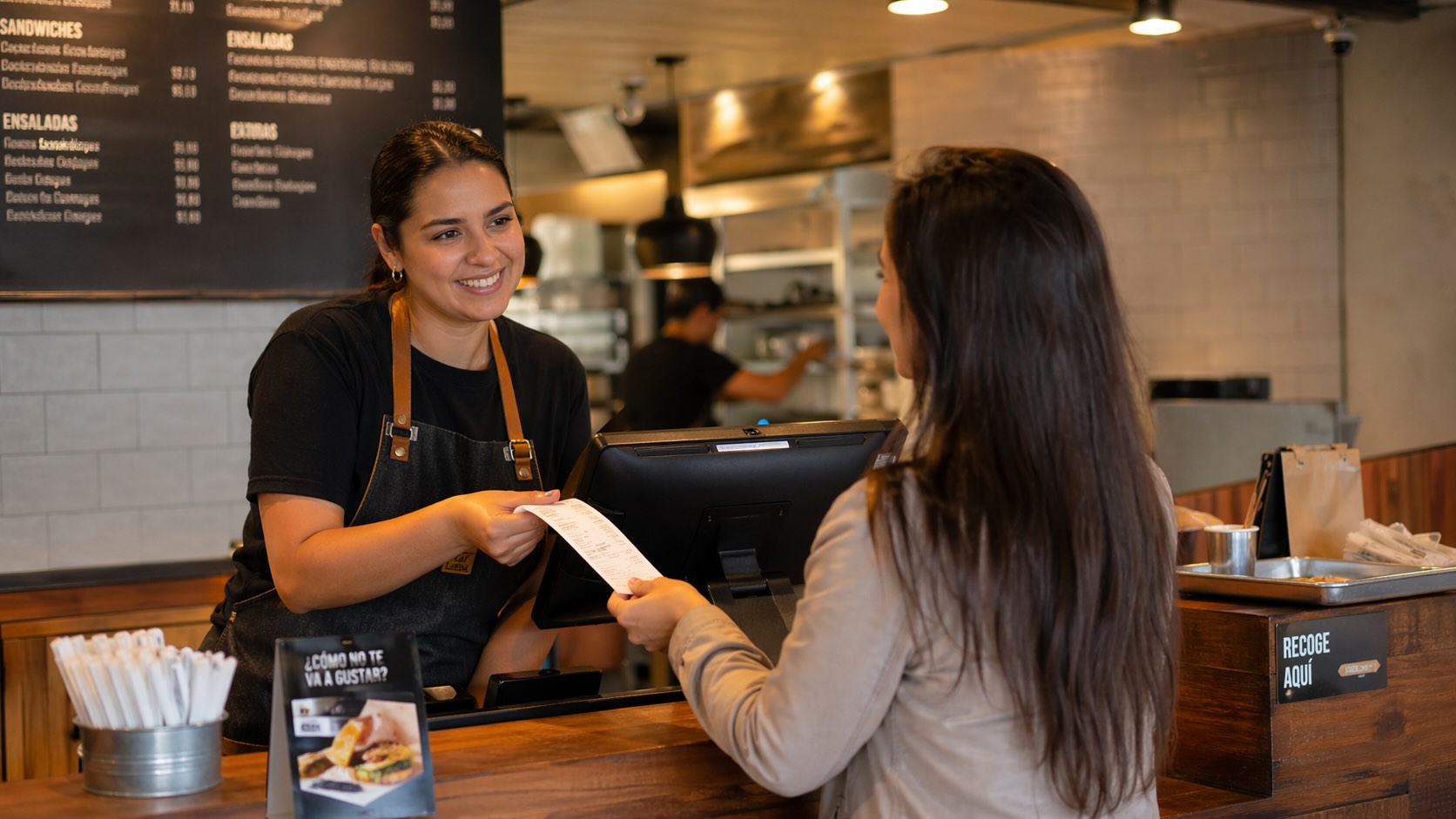 Team registering customers at checkout